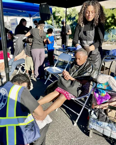 Community member receiving support at a Soul Saving Productions outreach event
