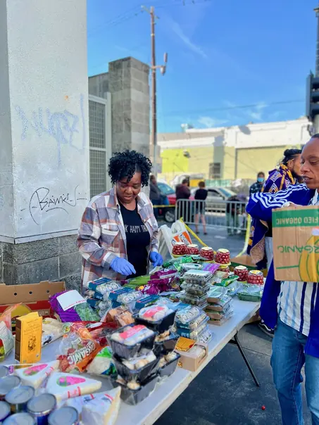Volunteers and community members sharing a meal during street outreach